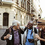 Close up of a group of male senior tourists exploring the city