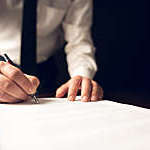 Businessman Signing An Official Document